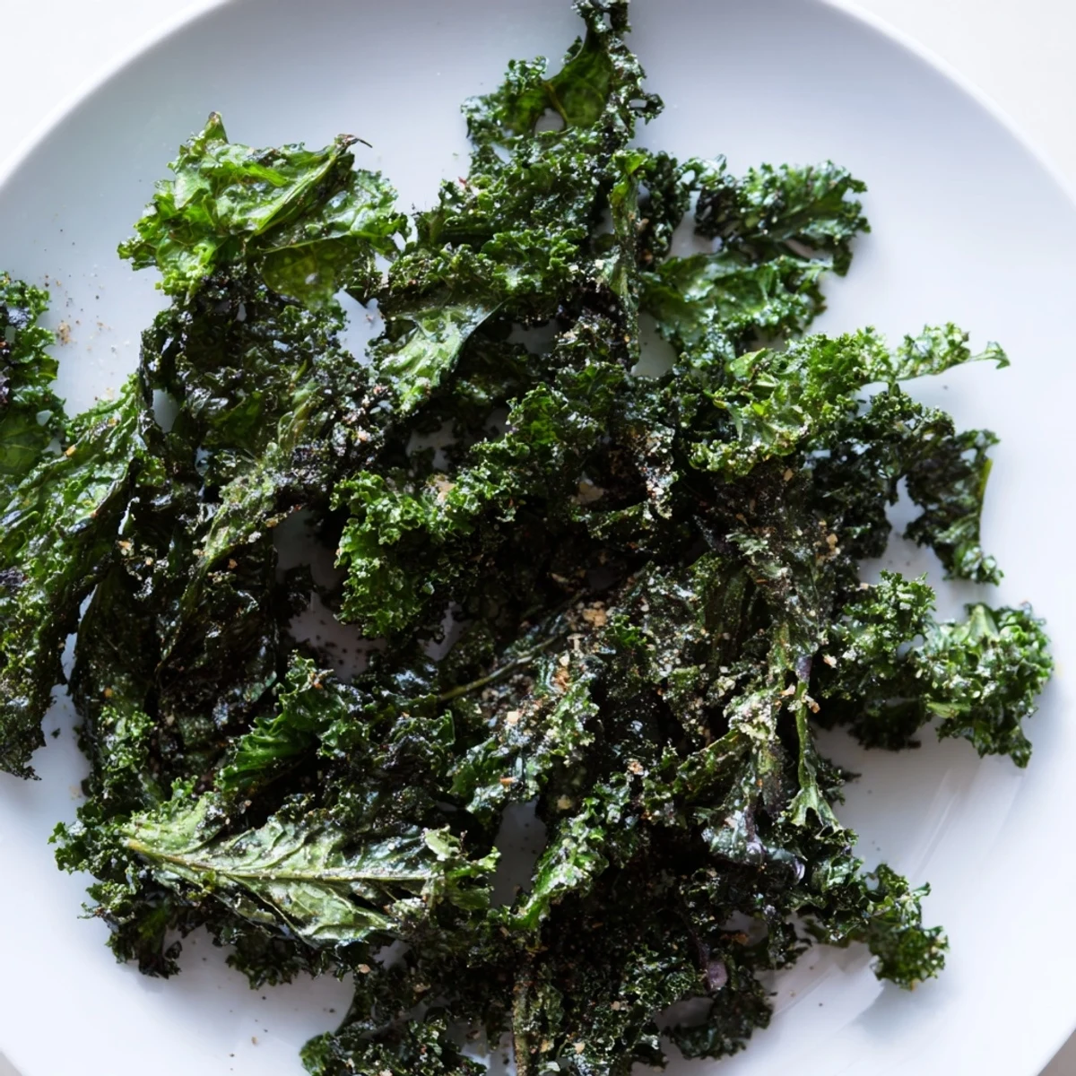 Golden, crispy oven-baked kale chips, a healthy snack, ready to be devoured with perfect seasonings.