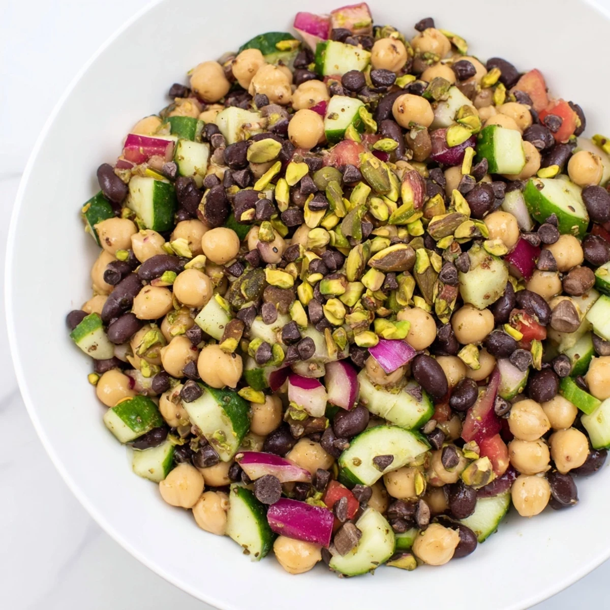 A vibrant Dense Bean Salad with Dubai Chocolate Notes, ready to serve with pistachios and cacao.