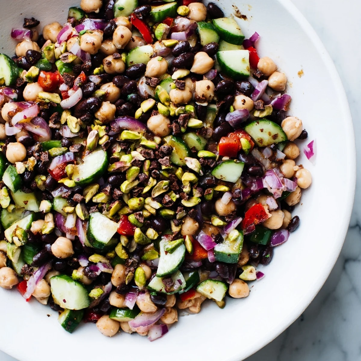 Close-up of a colorful Dense Bean Salad with Dubai Chocolate Notes, showcasing fresh herbs and textures.