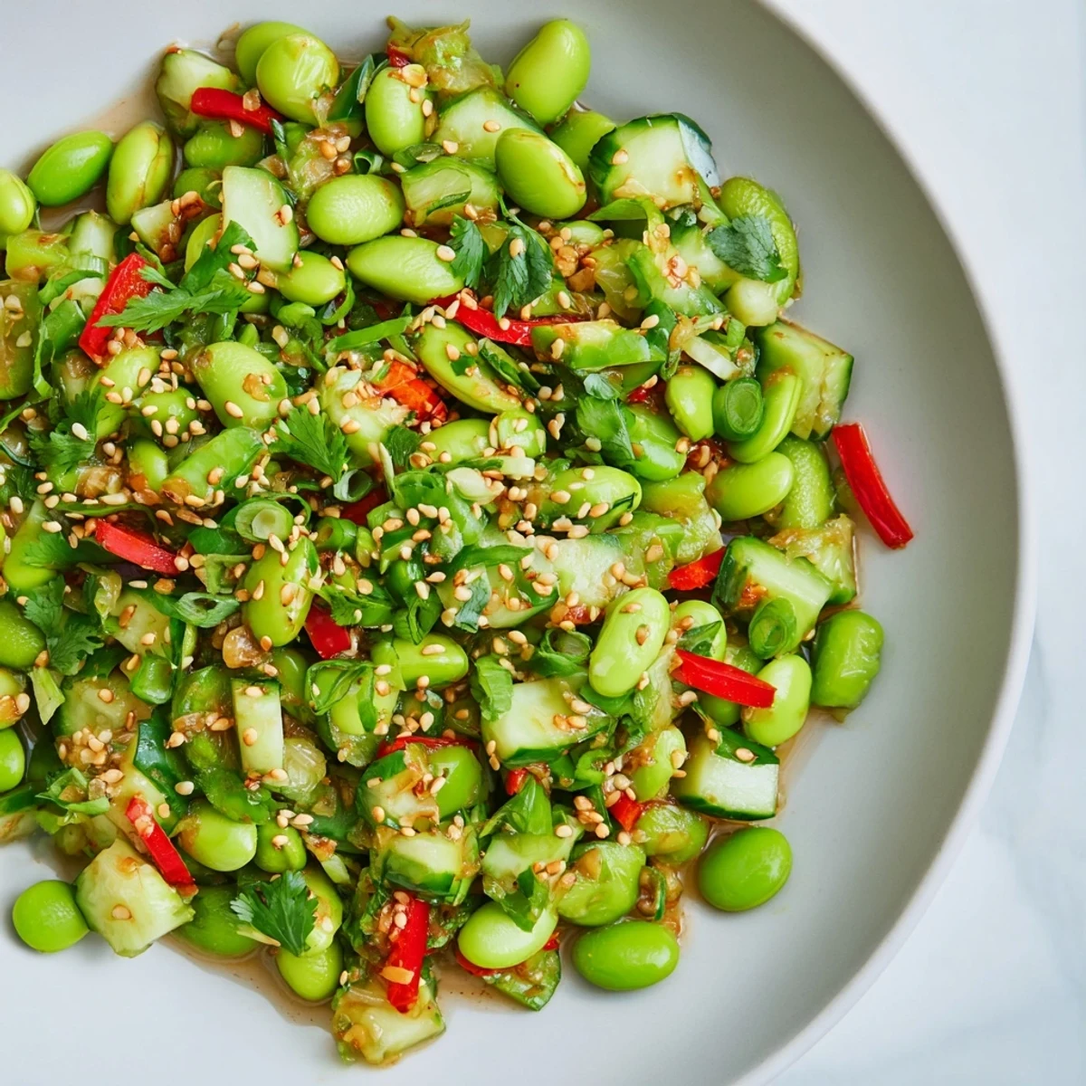A colorful bowl of fresh edamame salad, ready to eat with a flavorful Asian twist.