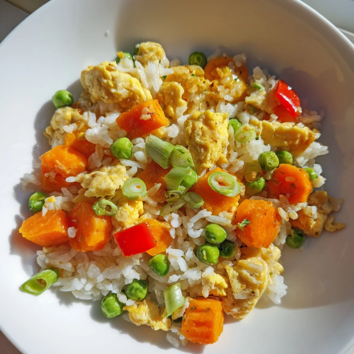 Fluffy scrambled eggs and colorful vegetables mix with savory soy sauce in this classic Egg Fried Rice stir-fry.  