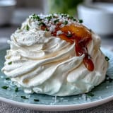 Two delicate cloud eggs, baked fluffy and topped with a vibrant, just-set yolk.