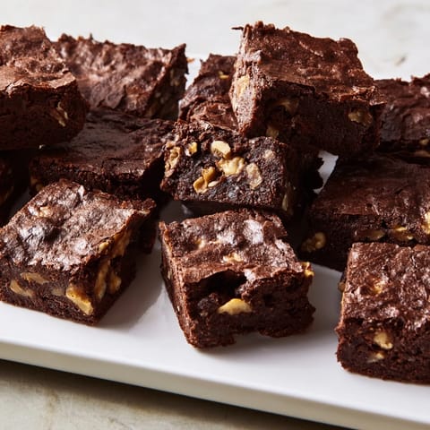Freshly baked, decadent fudgy walnut brownies: a single pan holds these gooey treats.
