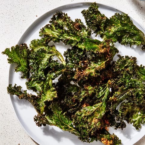 Freshly baked kale chips, tossed with olive oil and spices, offer a savory crunch experience everyone will love.