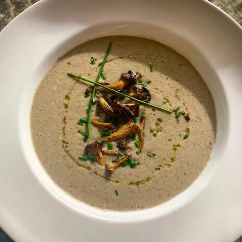 A close-up shot of rich, velvety Creamy Mushroom Bisque, showcasing its appealing texture.