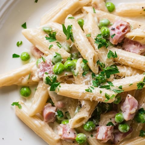Spring Pea & Ham Pasta features tender pasta ribbons coated in velvety cream, speckled with sweet peas and ham.  