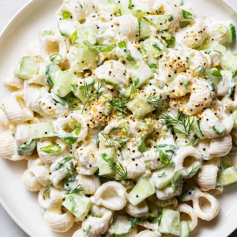 A close-up of creamy Cucumber Crunch Pasta Salad with diced cucumbers and everything bagel seasoning, served as a refreshing vegetarian side.