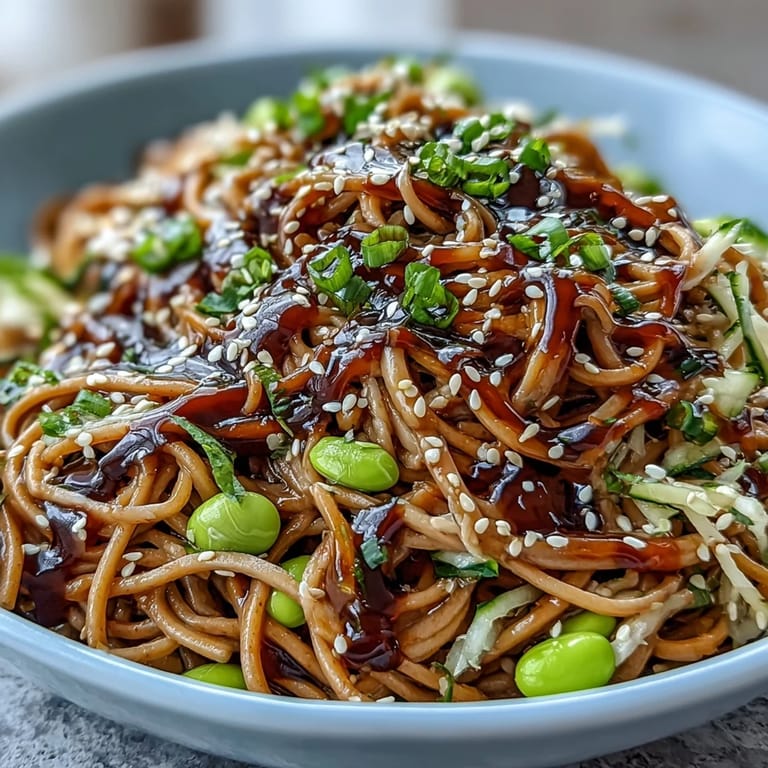 Colorful bowl of Sesame Ginger Noodles brightened with fresh ginger and crunchy toppings.