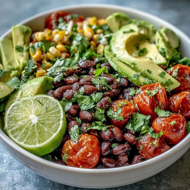 A colorful Plant-Based Taco Bowl ready to be enjoyed with lime wedges.