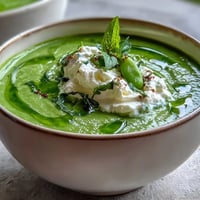 Spring Pea Soup with Whipped Ricotta and Mint Oil, a vibrant, creamy bowl.